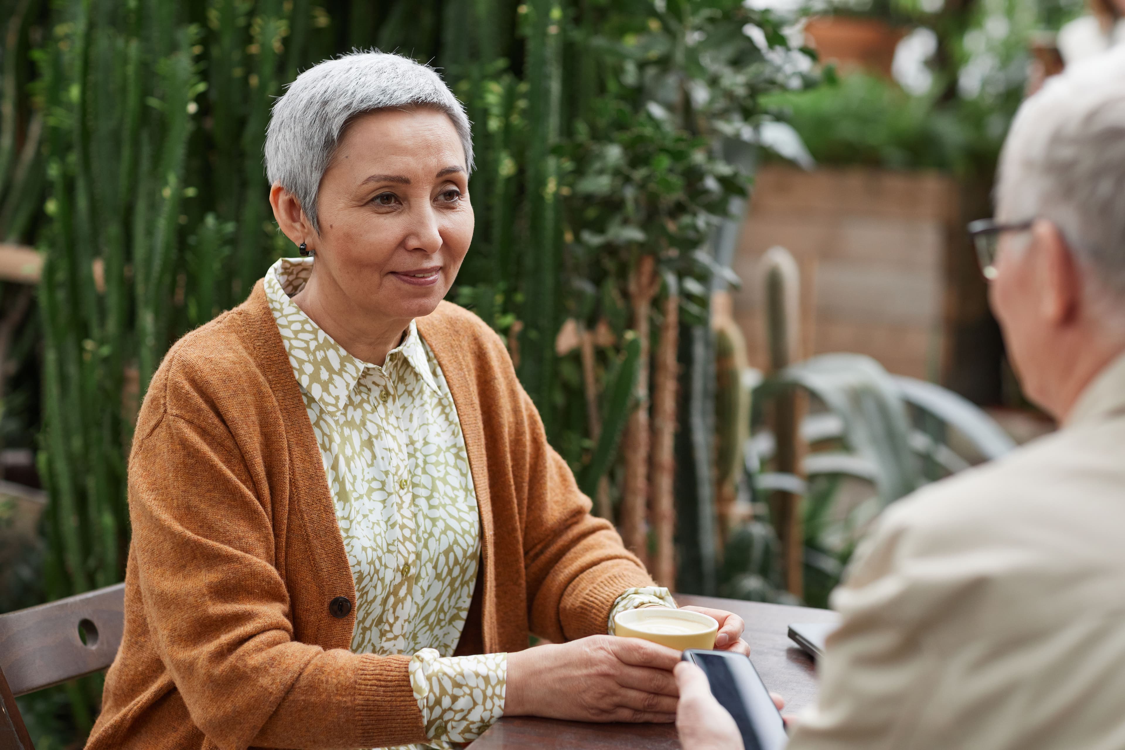 Older adults discussing plans together over coffee